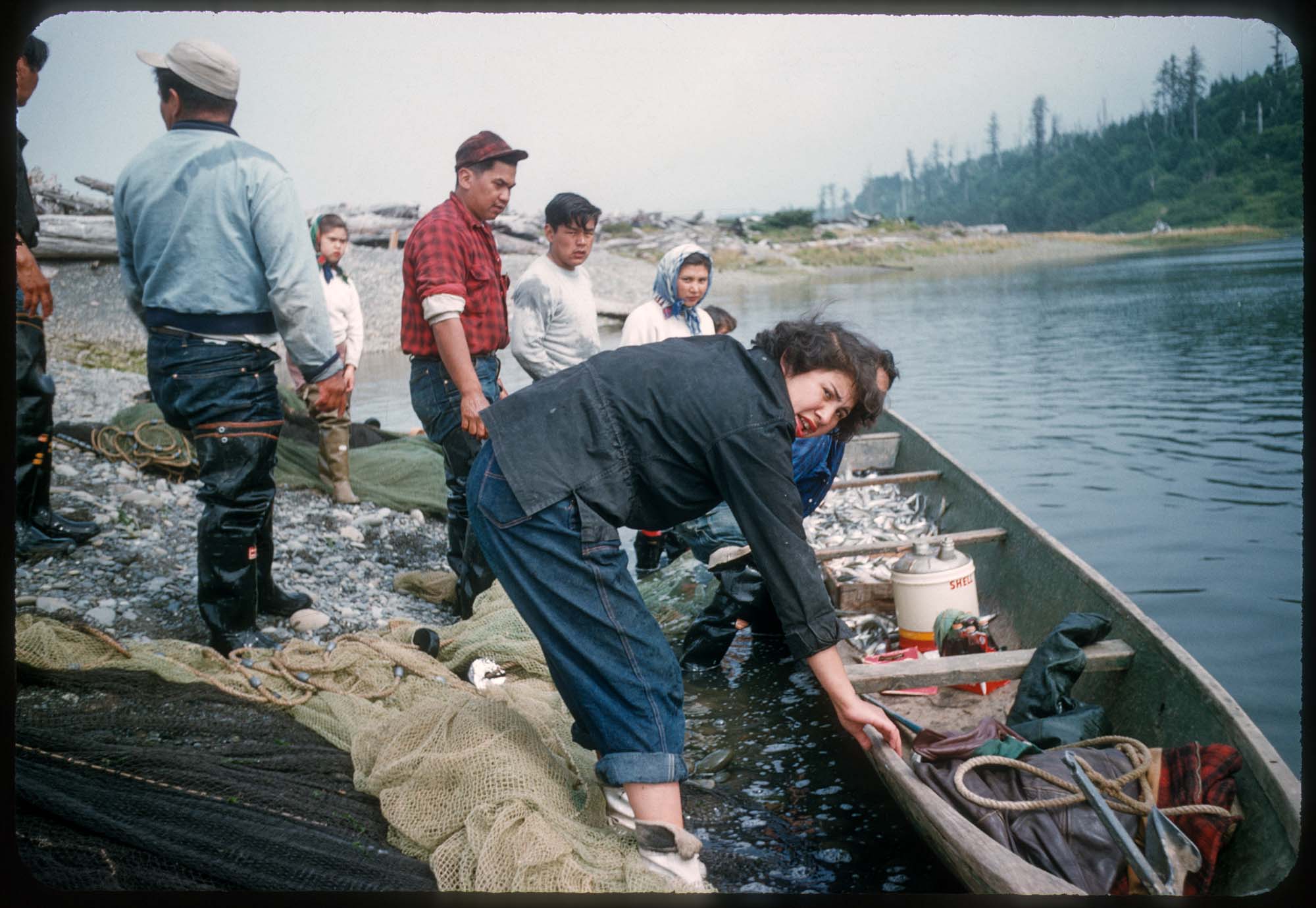 Image of Group of people tending to a fishing canoe, La Push, Washington, circa 1955