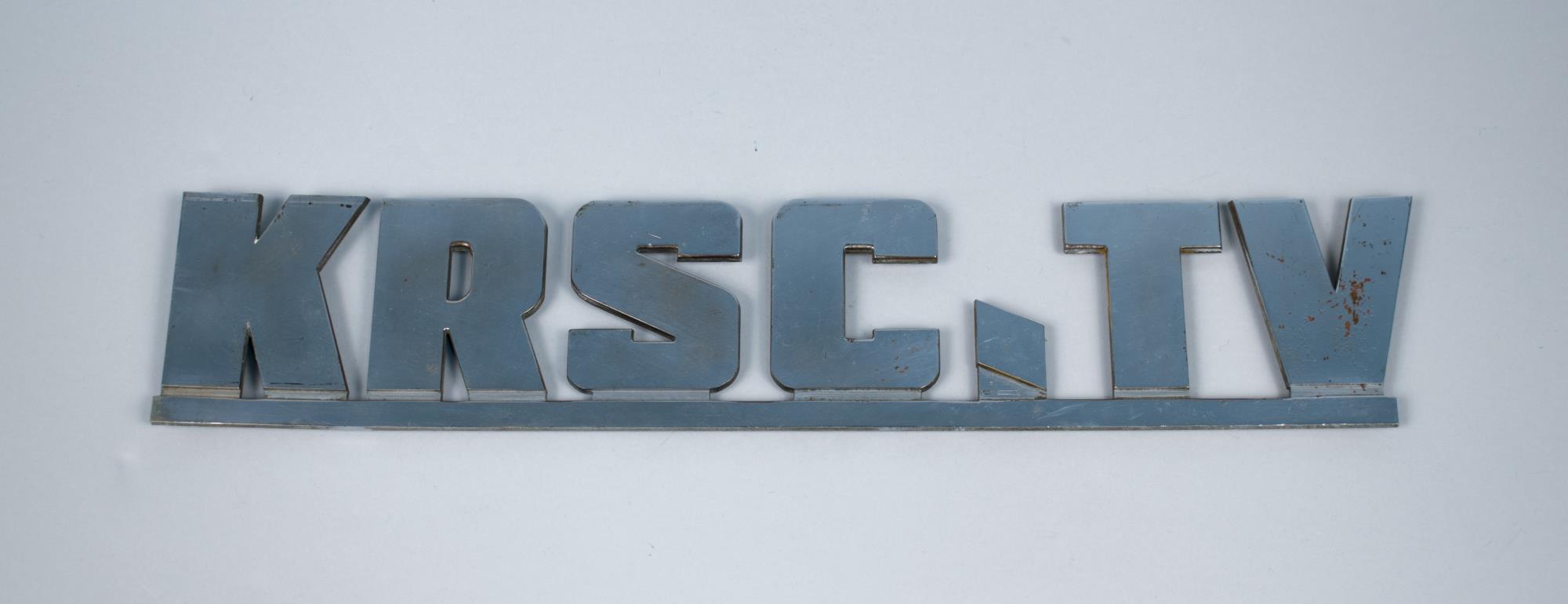 Image of Chrome-plated sign for KRSC TV, first television station in Seattle, established in 1948