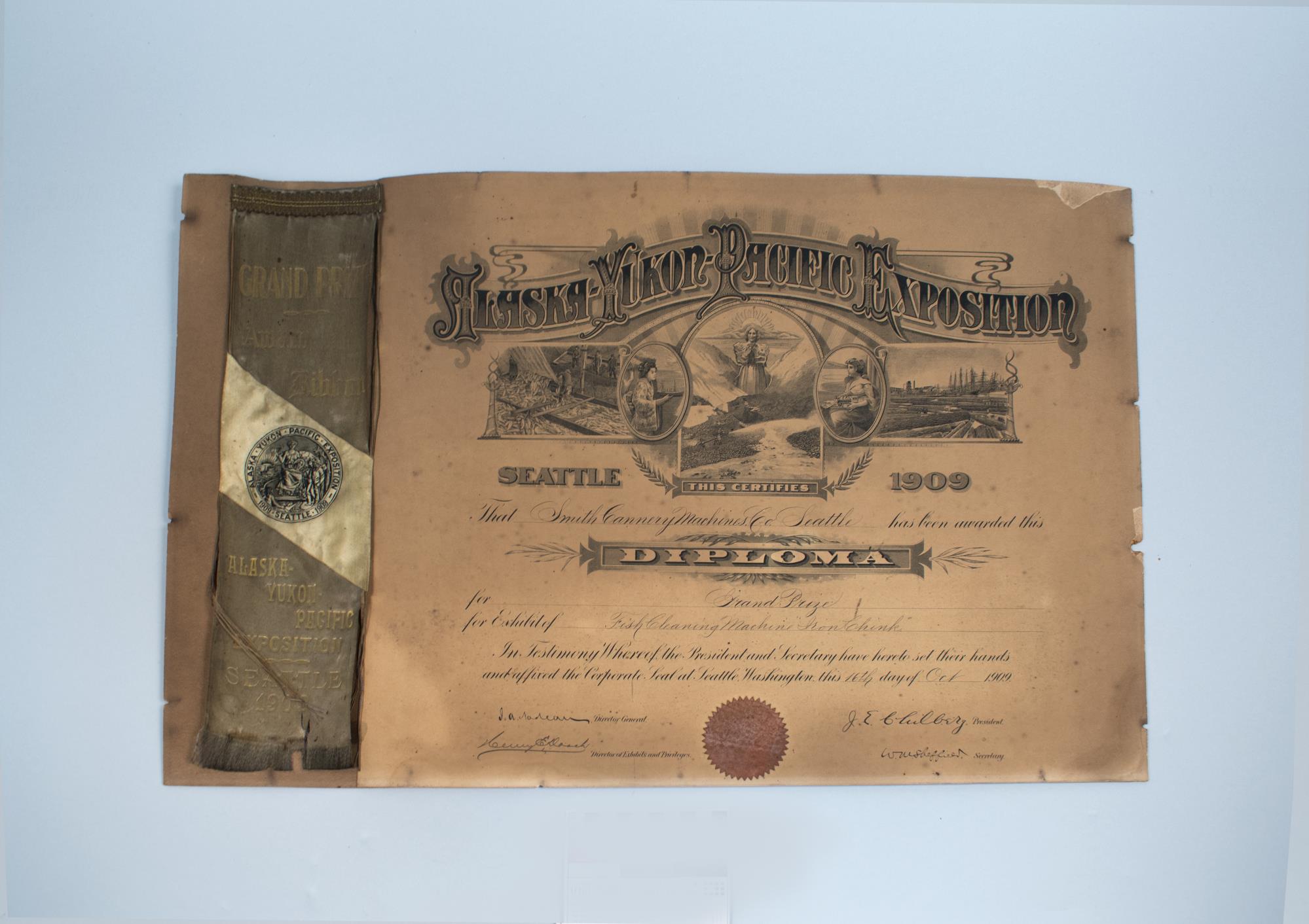 Image of Alaska-Yukon-Pacific Exposition (AYPE) Diploma and Grand Prize ribbon awarded to Smith Cannery Machines Co. for the 