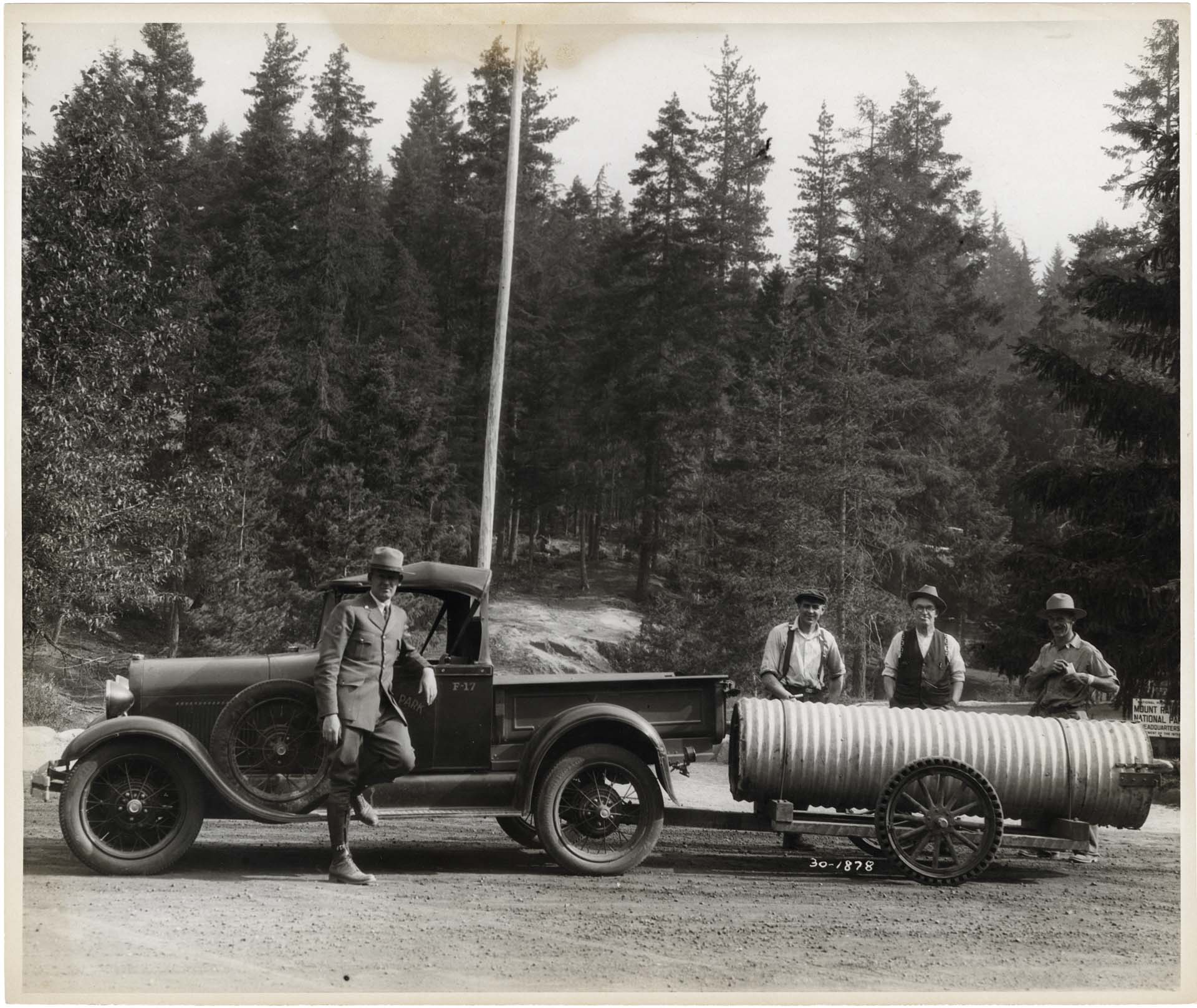 Image of Park Ranger Charles Brown and others with bear trap, Mount Rainier National Park, 1930