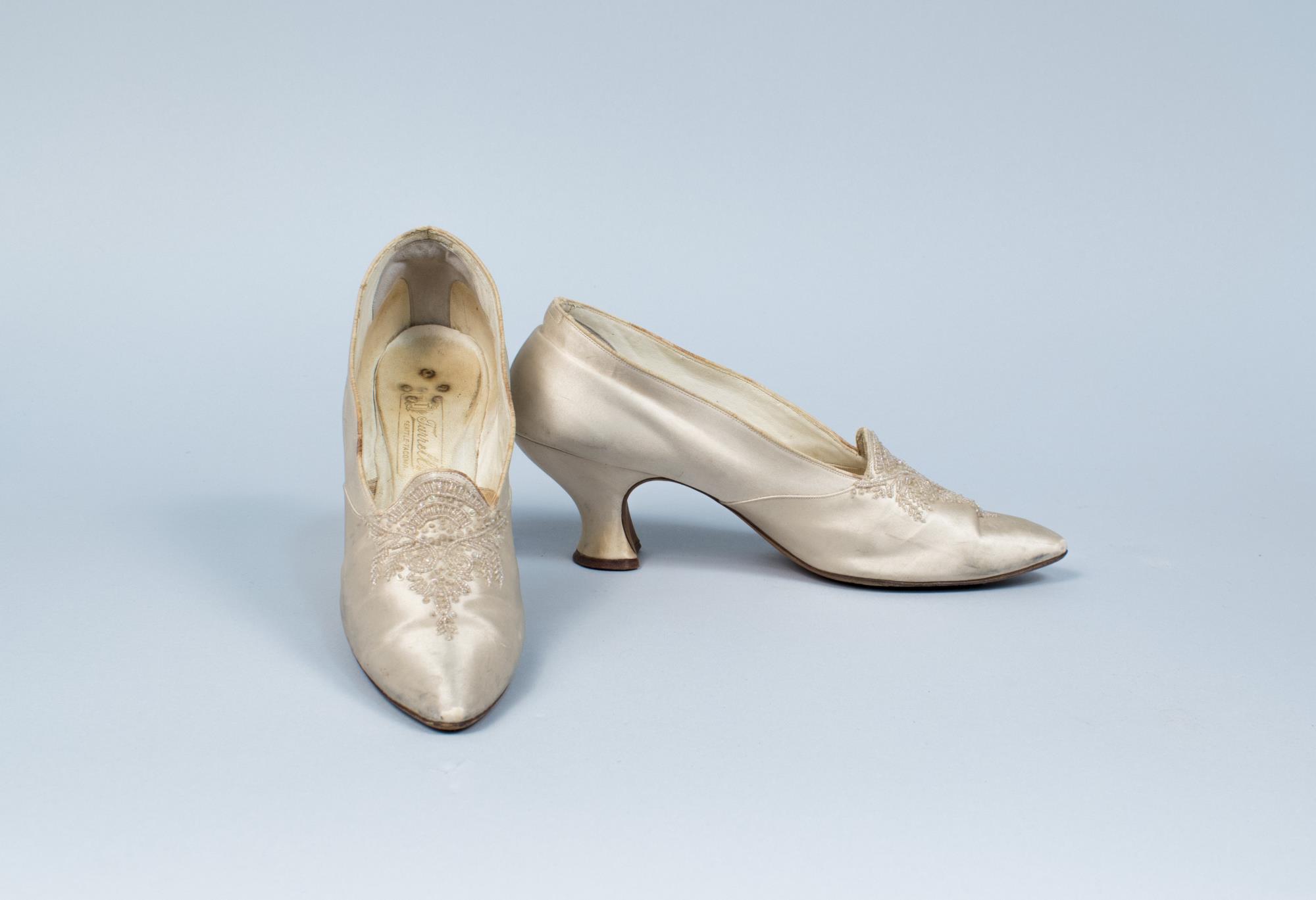 Image of Pair of cream satin wedding shoes with beaded toe, from Turrell's Seattle, ca. 1910s