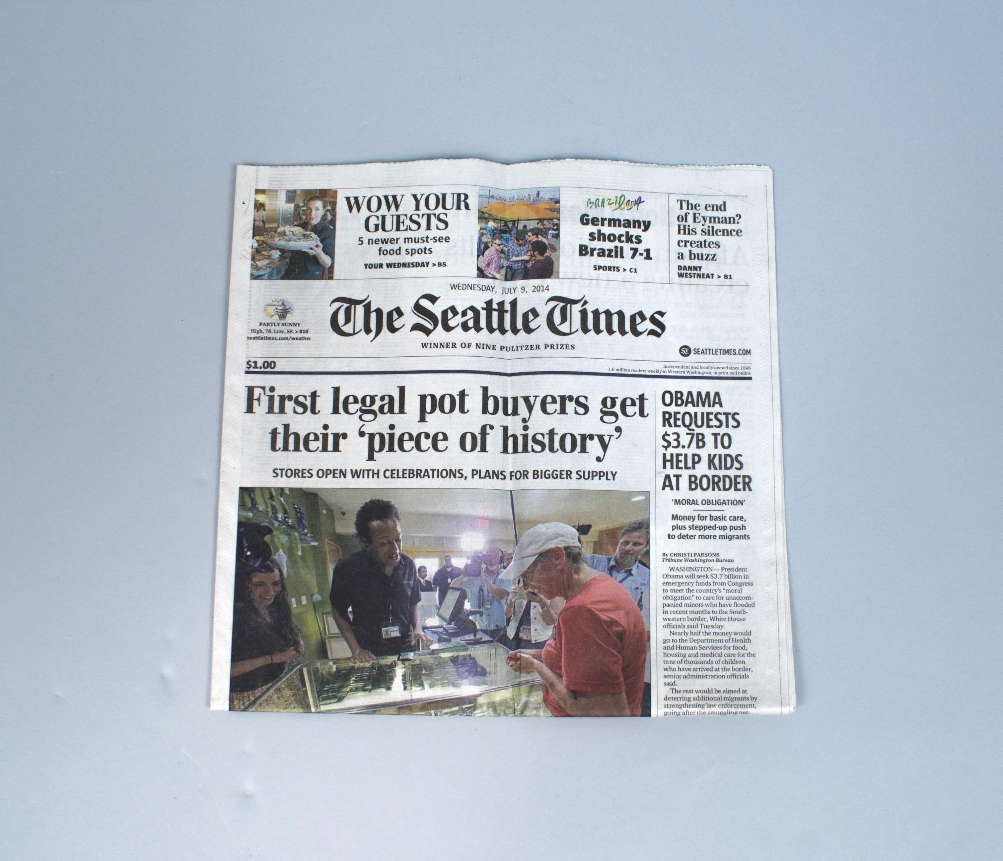 Image of Front page of the Seattle Times dated July 9, 2014, featuring the lead story on Deb Greene purchasing the first legal recreational marijuana from Cannabis City store in Seattle