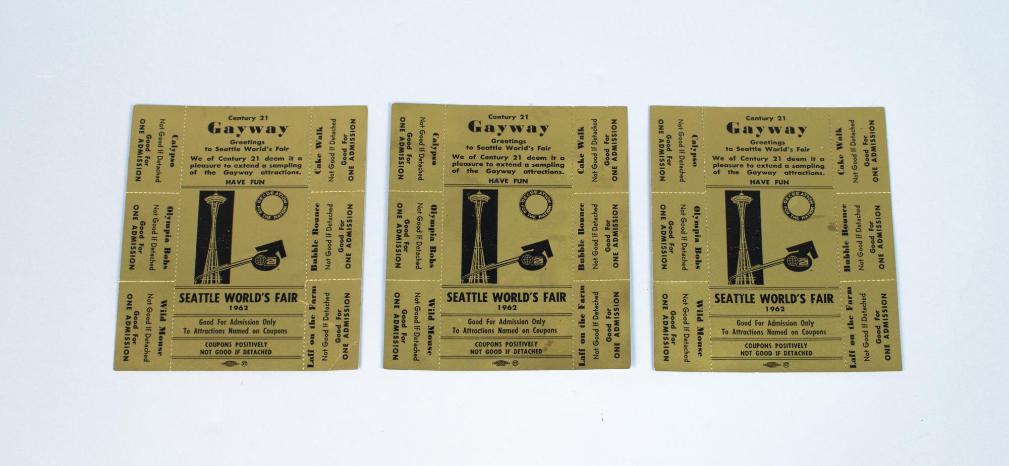 Image of Three golden admission tickets to attractions at the Century 21 Seattle World's Fair Gayway, 1962