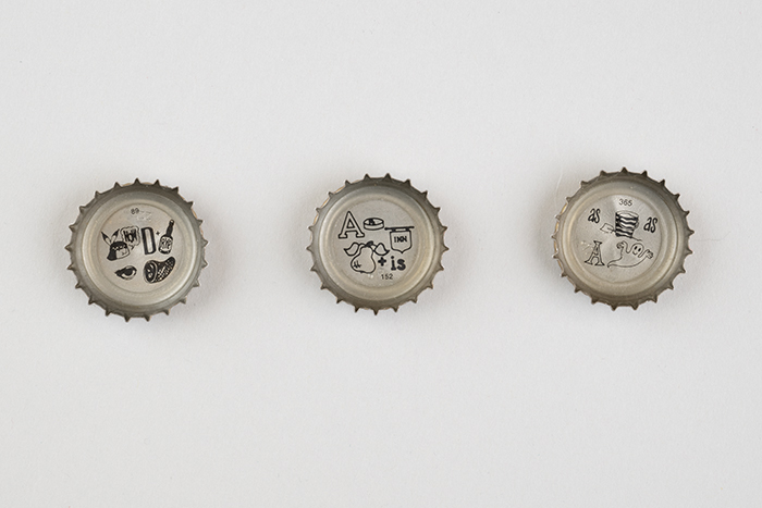Image of Set of three Rainier Mountain Pale Ale beer bottle caps with rebus puzzles, 2016