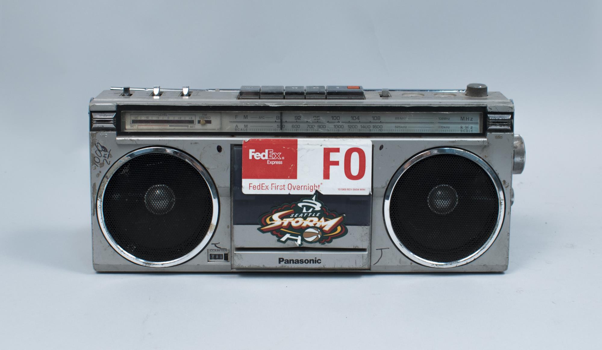 Image of Boom box with Fed Ex sticker, owned and used by Rob Castro (R.B. Cummings), ca. 1990s