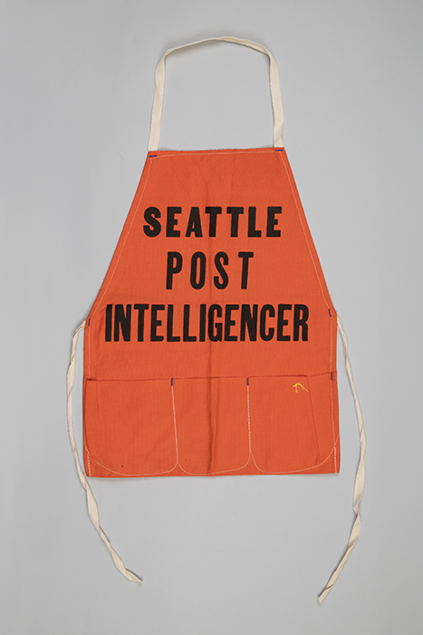 Image of Orange Seattle Post-Intelligencer sales apron, ca. 1950s-1960s