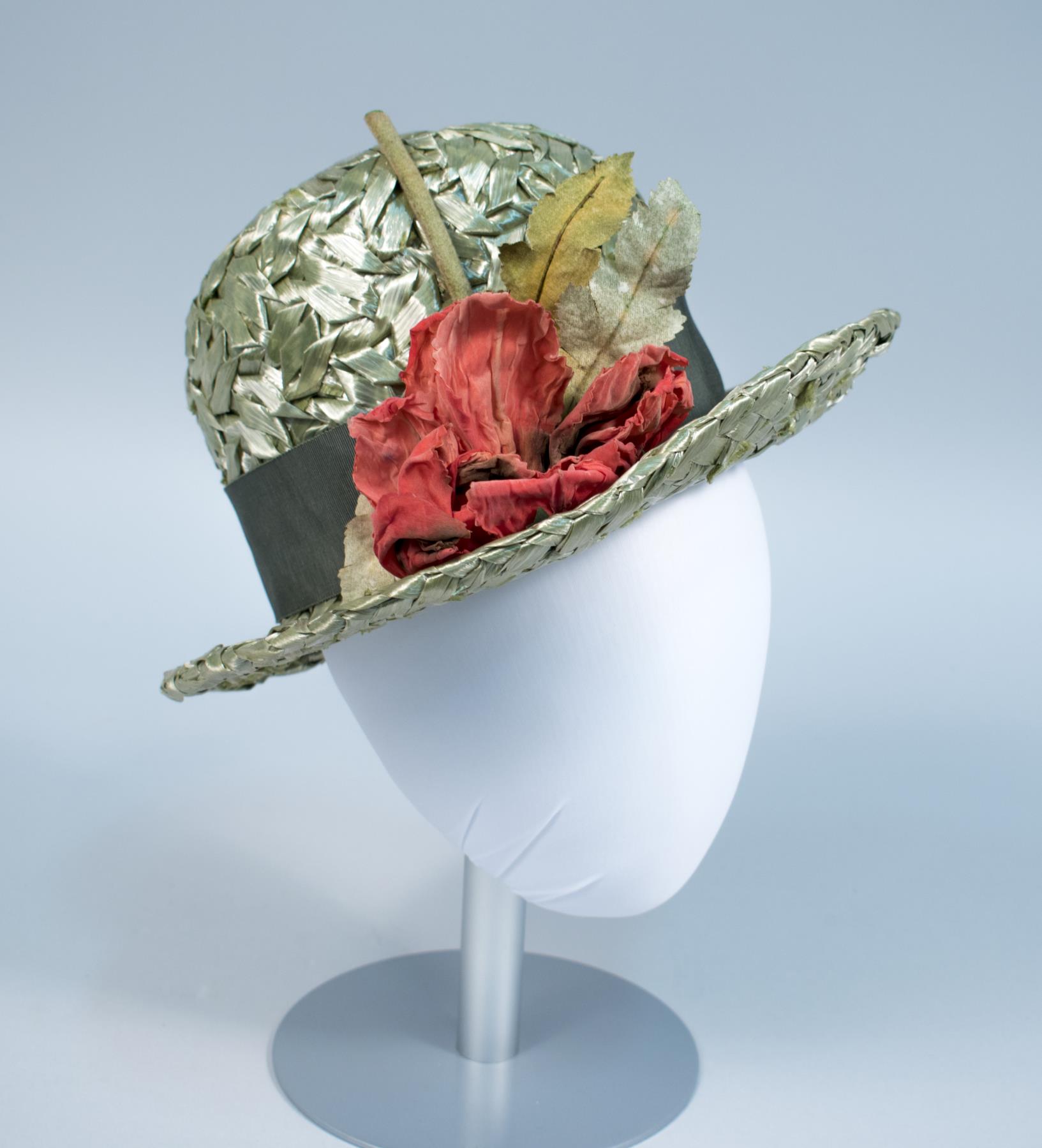 Image of Green straw hat with flower, made by John Eaton, 1960s