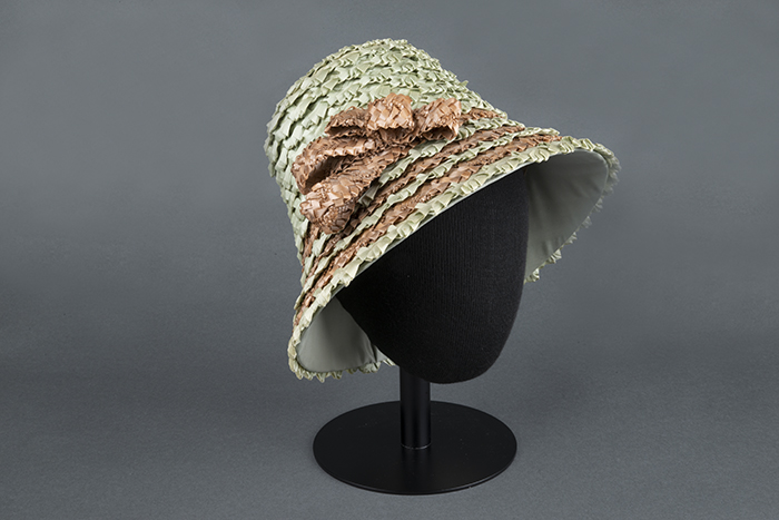 Image of Green and brown straw hat, made by Izzie Lewis, ca. 1990s