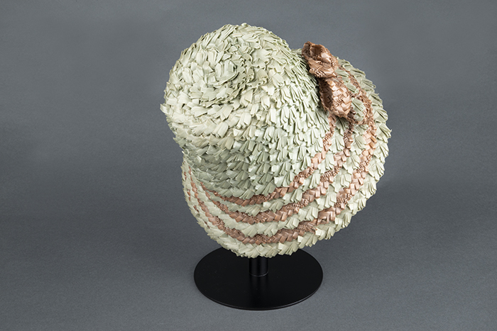 Image of Green and brown straw hat, made by Izzie Lewis, ca. 1990s