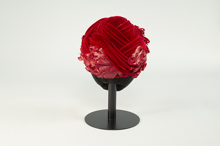 Image of Red velvet hat with feathers, sold at Best's Apparel, ca. 1950s-1960s