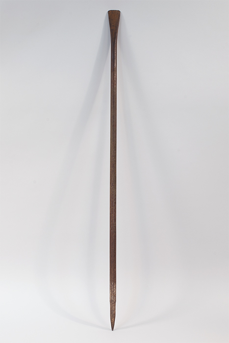 Image of Long steel bar used for digging power pole holes, ca. 1910s-1940s