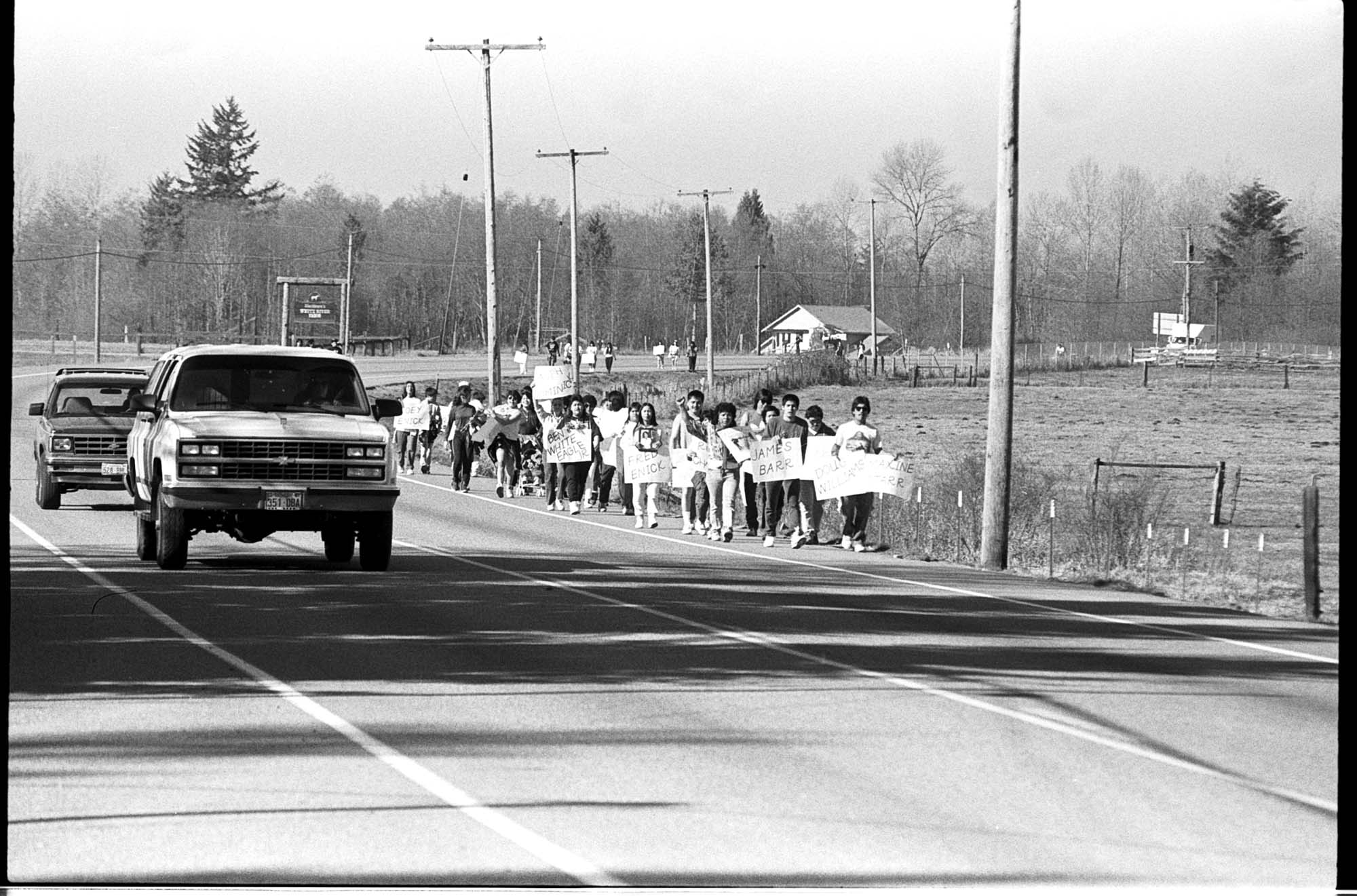 Image of Muckleshoot memorial and protest march alongside cars on Highway 164, February 27, 1991