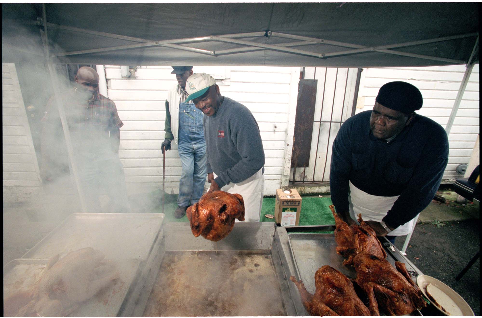 Image of Woody Jackson and Henry Williams frying turkeys outside Catfish Corner, Seattle, November 20, 2001