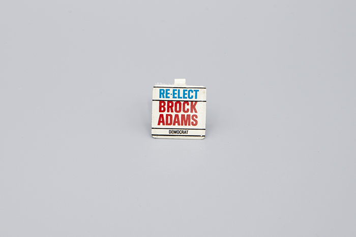 Image of Re-Elect Brock Adams pin, ca. 1980s