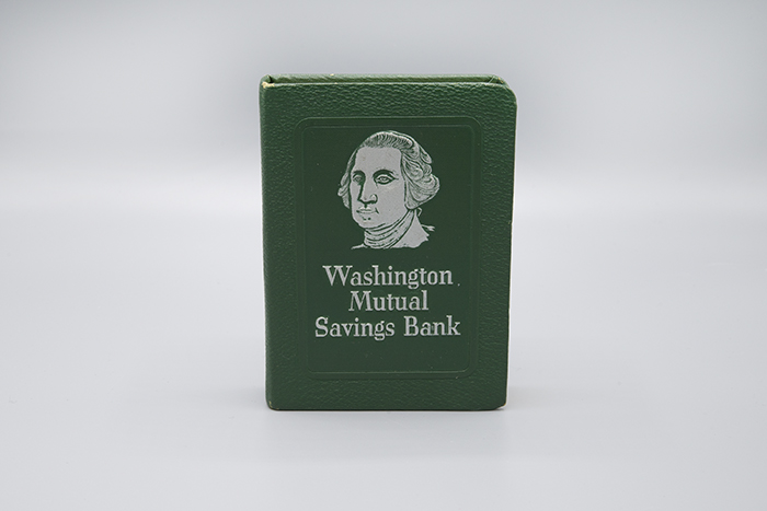 Image of Metal coin bank in the shape of a book from Washington Mutual Savings Bank, ca. 1960