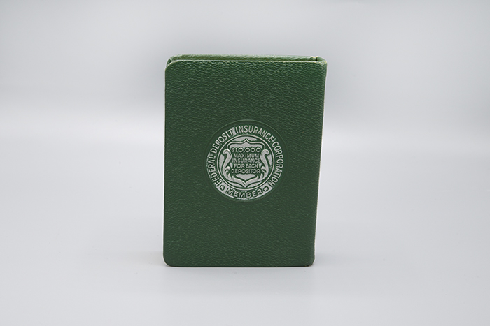 Image of Metal coin bank in the shape of a book from Washington Mutual Savings Bank, ca. 1960