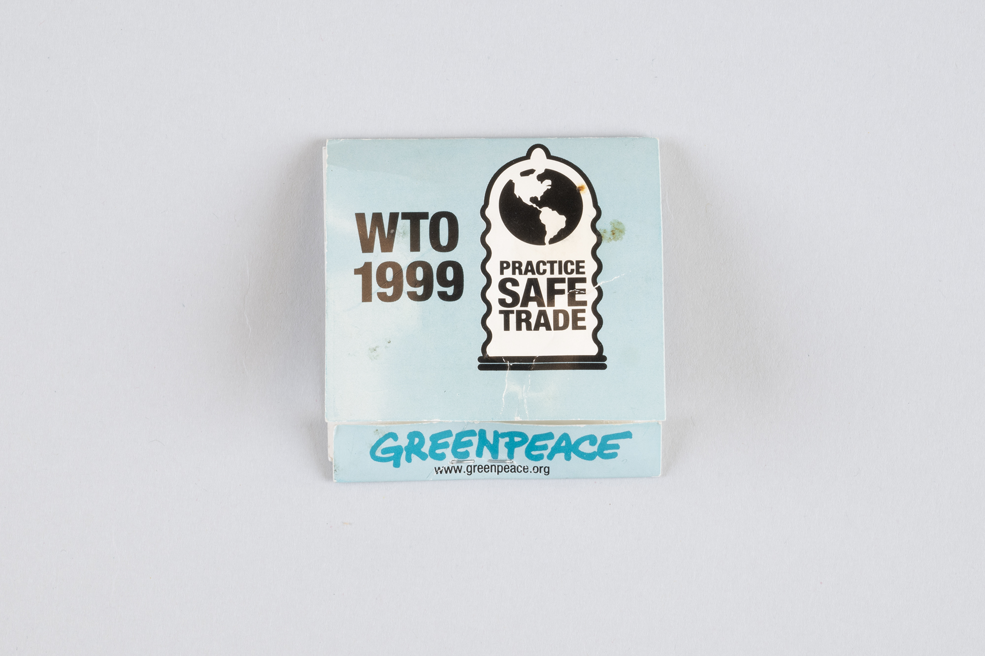 Image of Single packaged condom handed out by Greenpeace during WTO protests, 1999