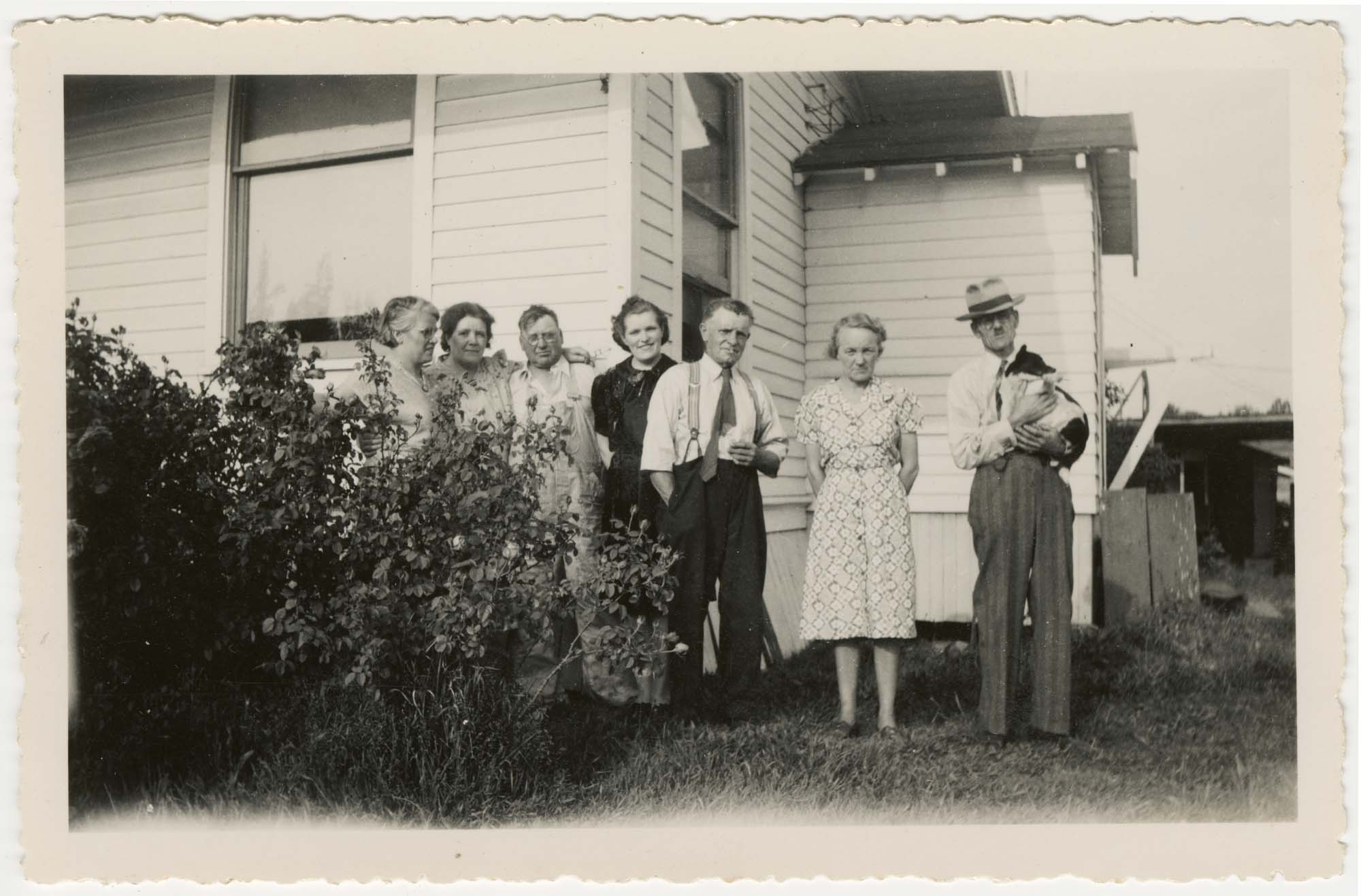Image of Anna and Franz Hardow posing with friends and family near house, Seattle, 1940