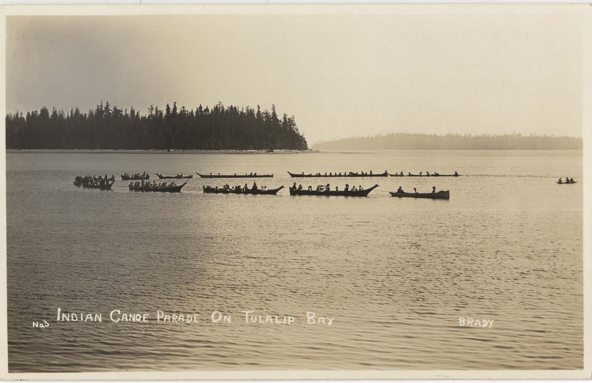 Image of Canoe parade on Tulalip Bay, circa 1912