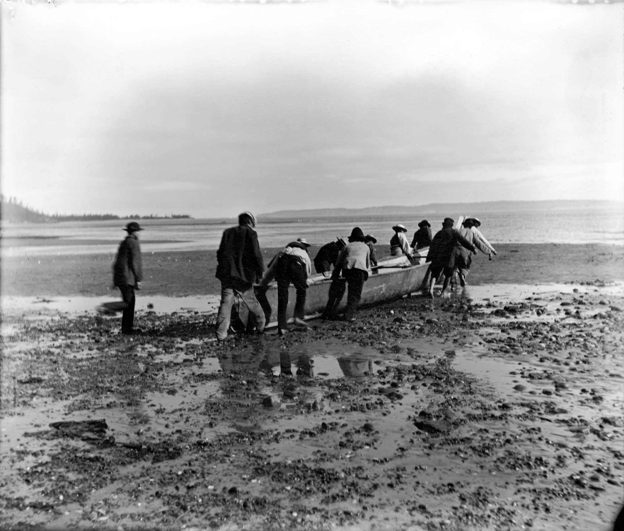 Image of Indigenous group launching their canoe at Port Townsend, August 30, 1899