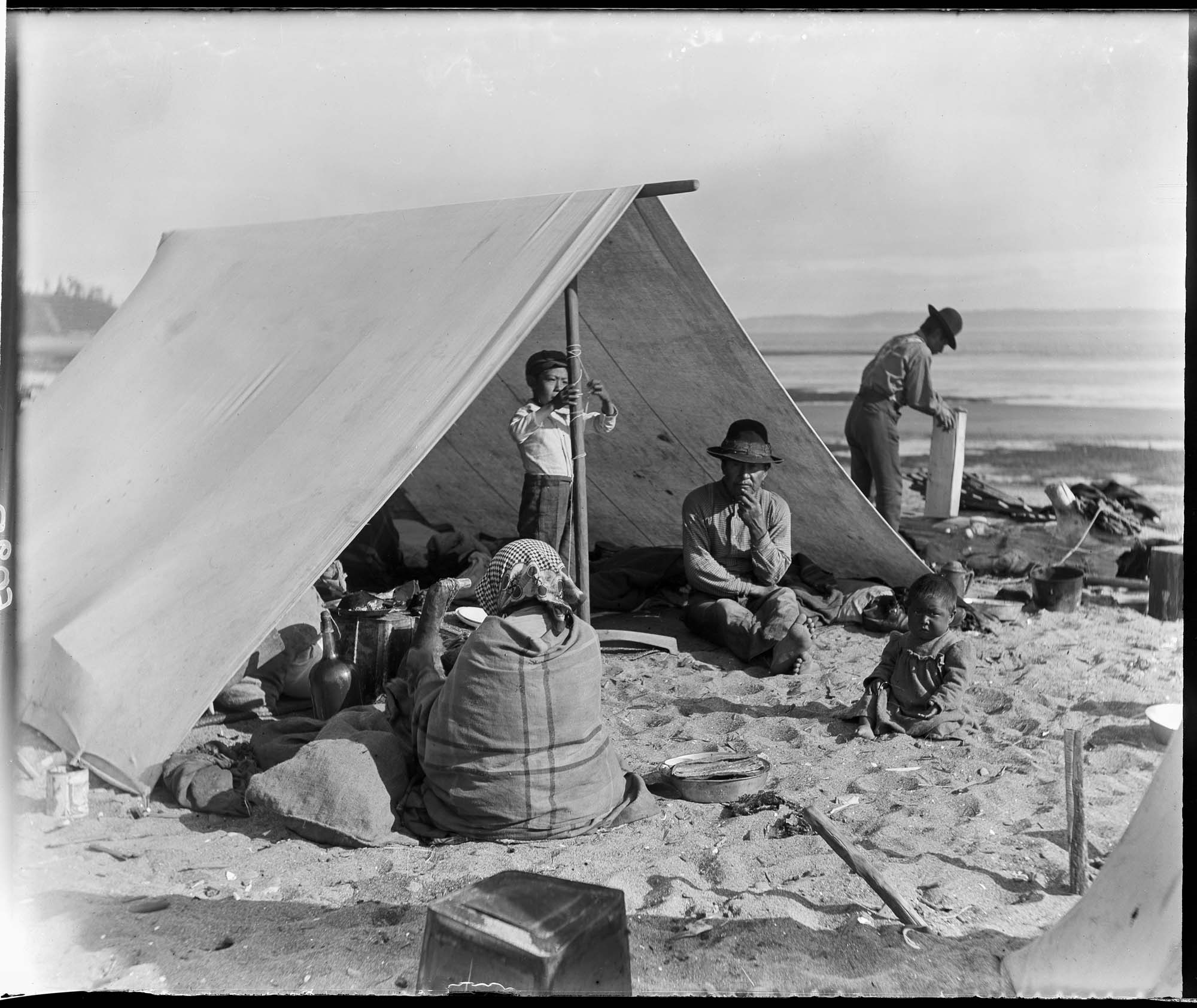 Image of Group of Makah people under a fly tent at Port Townsend, August 30, 1899