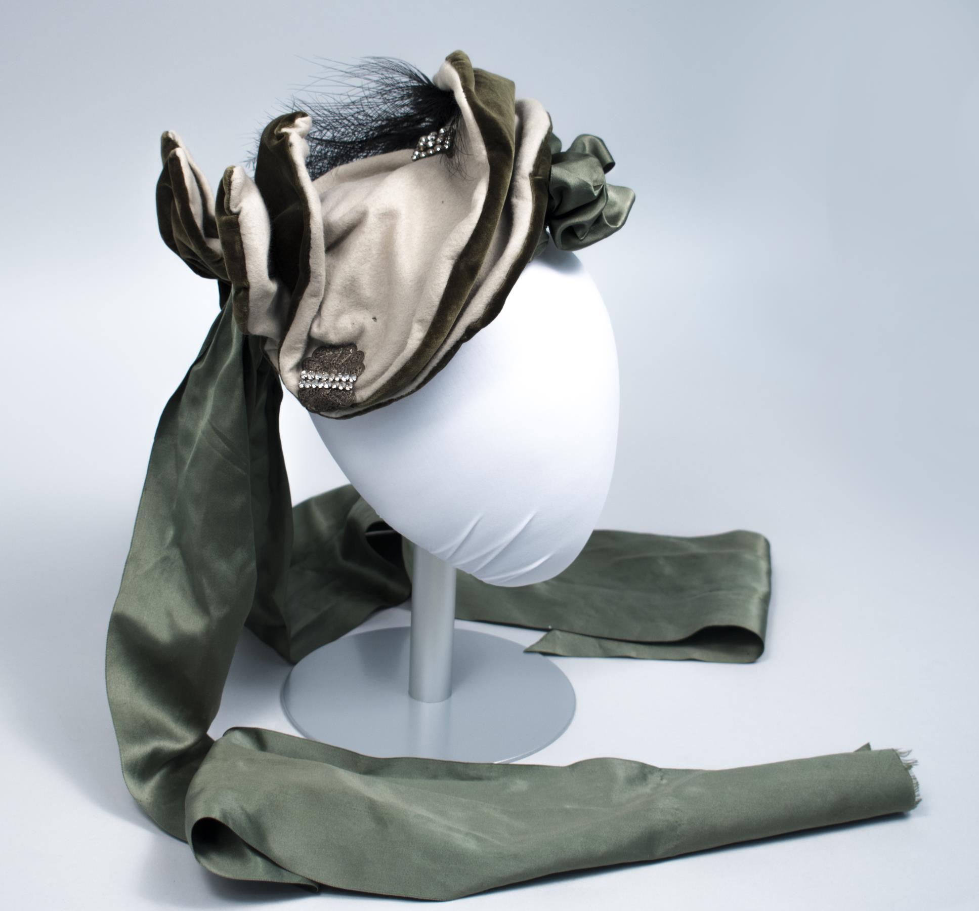 Image of Green velvet and taupe felt hat with rhinestone, ribbon, and feather trim, 1888