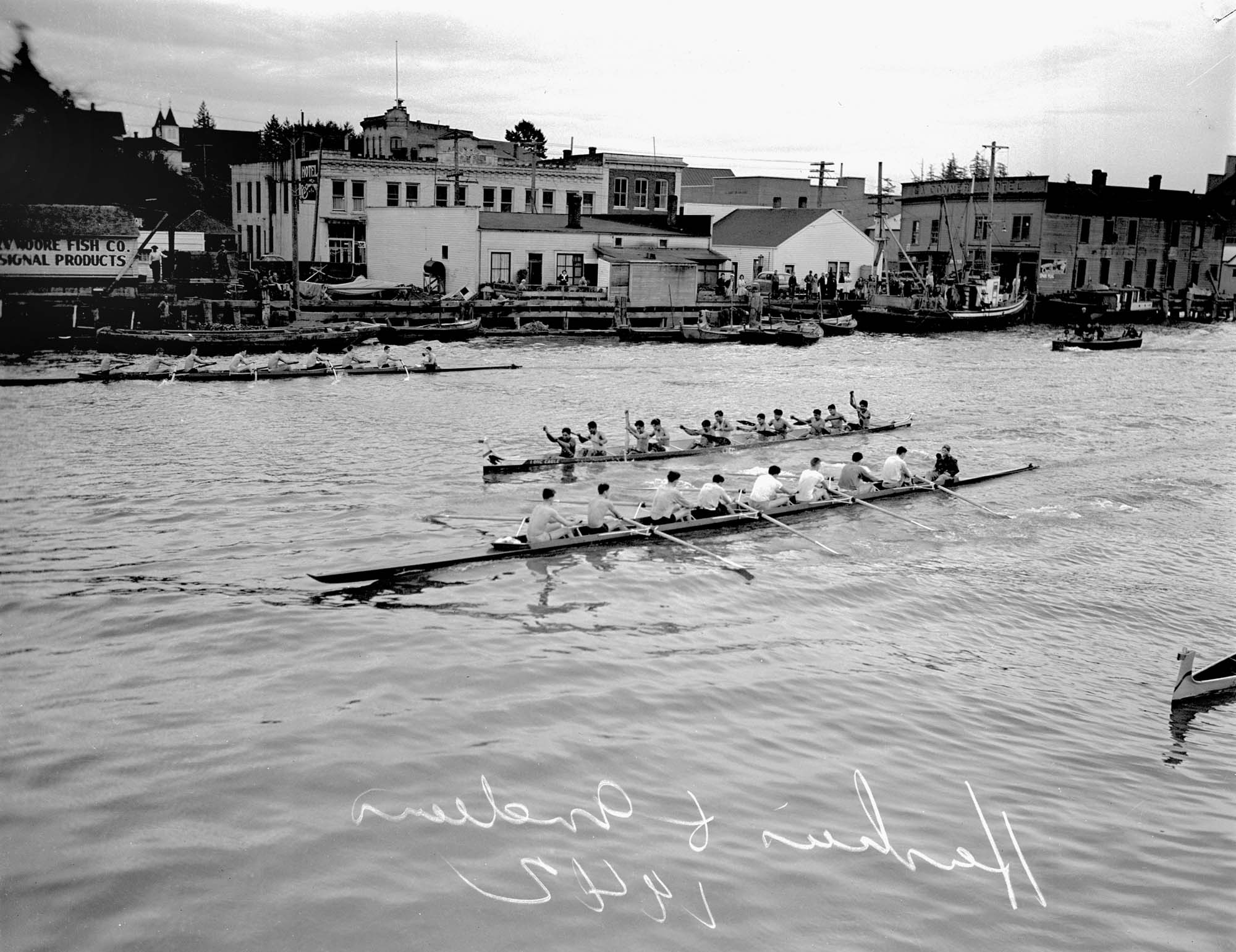 Image of Husky crew and Indigenous canoe race, La Conner, November 29, 1941