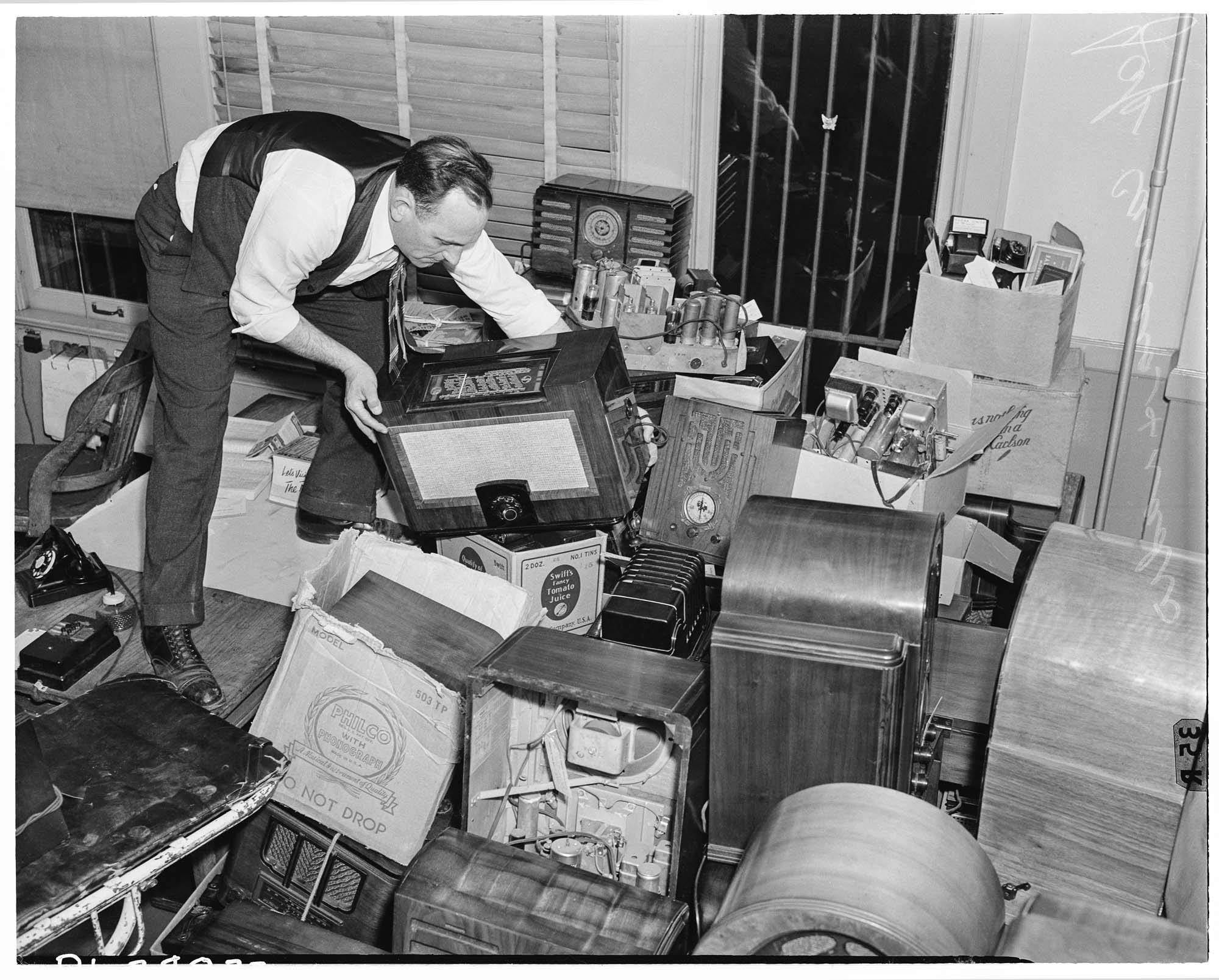 Image of Man stacking radios surrendered by Japanese Americans, Seattle, December 29, 1941