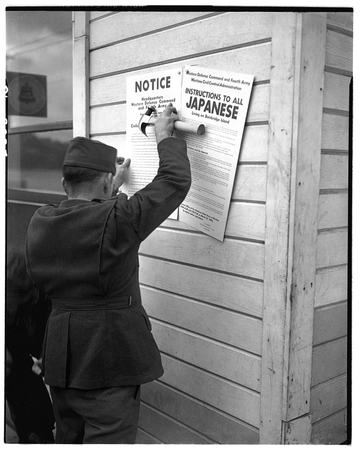 Image of Soldier posting Civilian Exclusion Order, Bainbridge Island, 1942