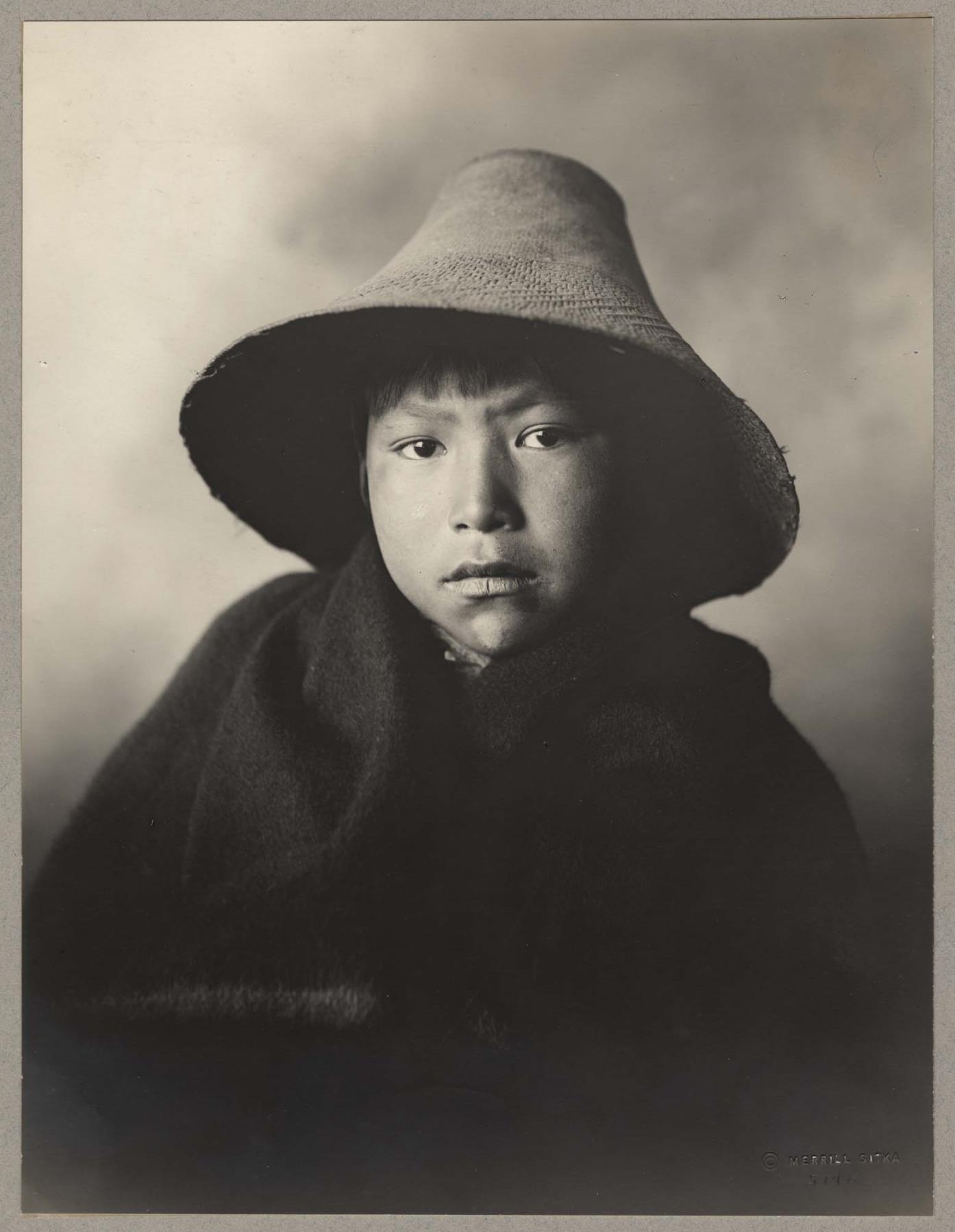 Image of Tlingit boy wearing a woven hat, Sitka, circa 1915