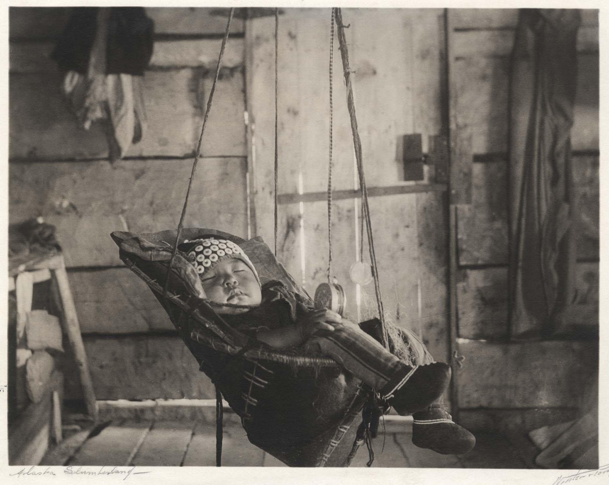 Image of Infant asleep in a sling, Alaska, circa 1905