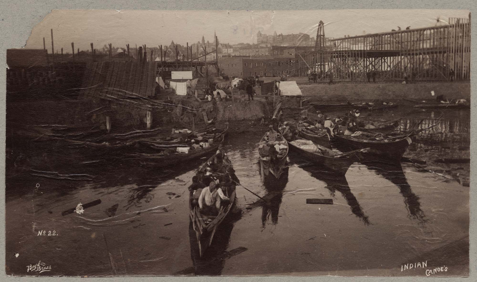 Image of Indigenous canoes docked at the Seattle waterfront, circa 1892