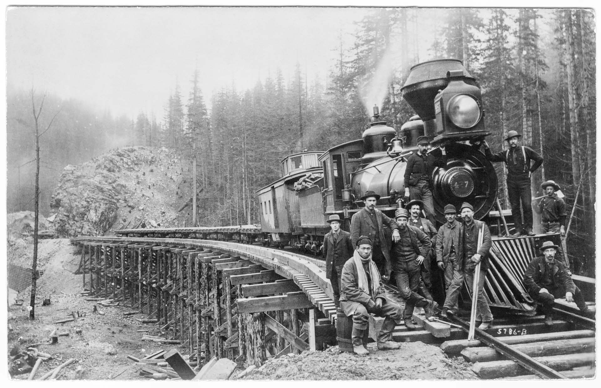 Image of Railroad construction workers and locomotive at the Green River crossing, 1885