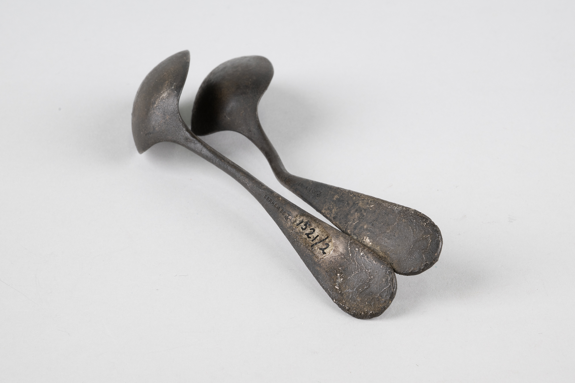 Image of Two silver spoons melted together from the Seattle Fire of 1889