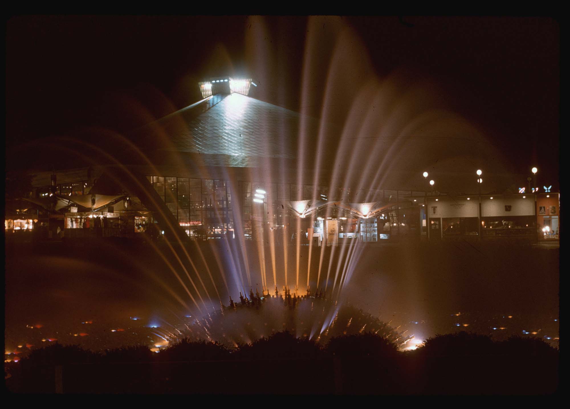 Image of The International Fountain and Washington State Coliseum at night, Seattle World's Fair, 1962