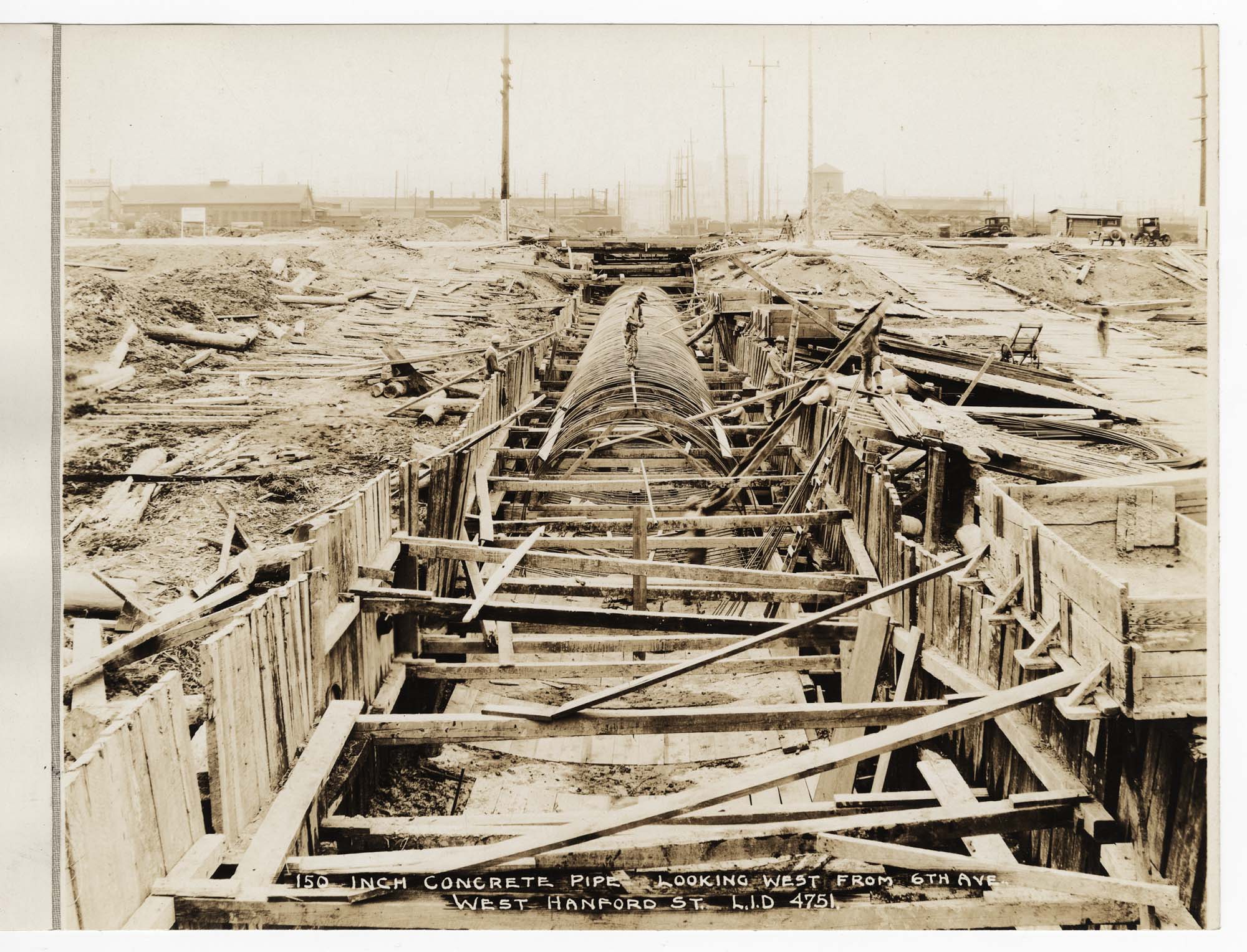 Image of Reinforced steel cable pipe frame in trench, circa 1929