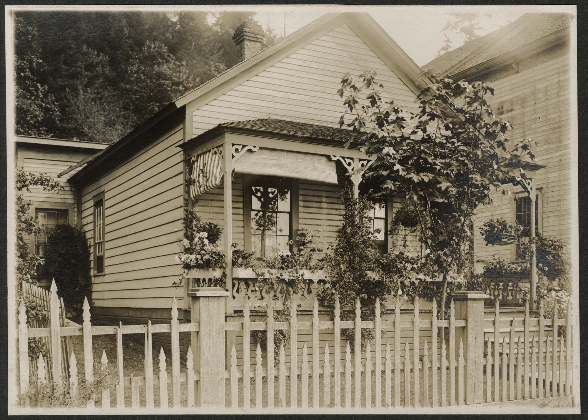 Image of Family on the porch of a mill house at Port Blakely, 1909