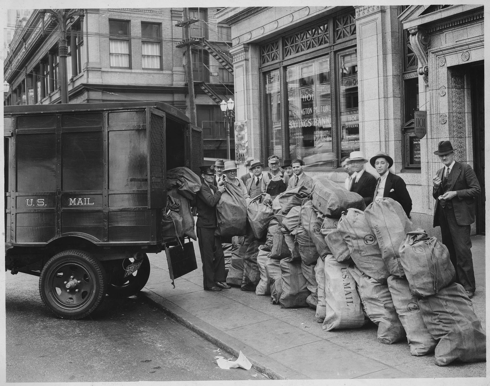 Image of Men with mail sacks and mail truck outside Washington Mutual Savings Bank, circa 1941