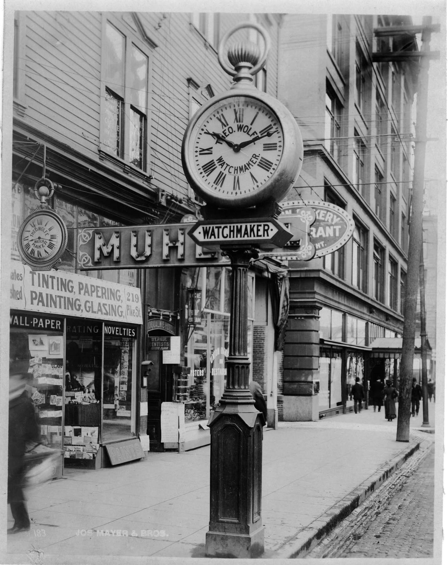 Image of Street clock in front of Theo Wolfe Watchmaker, Seattle, circa 1907