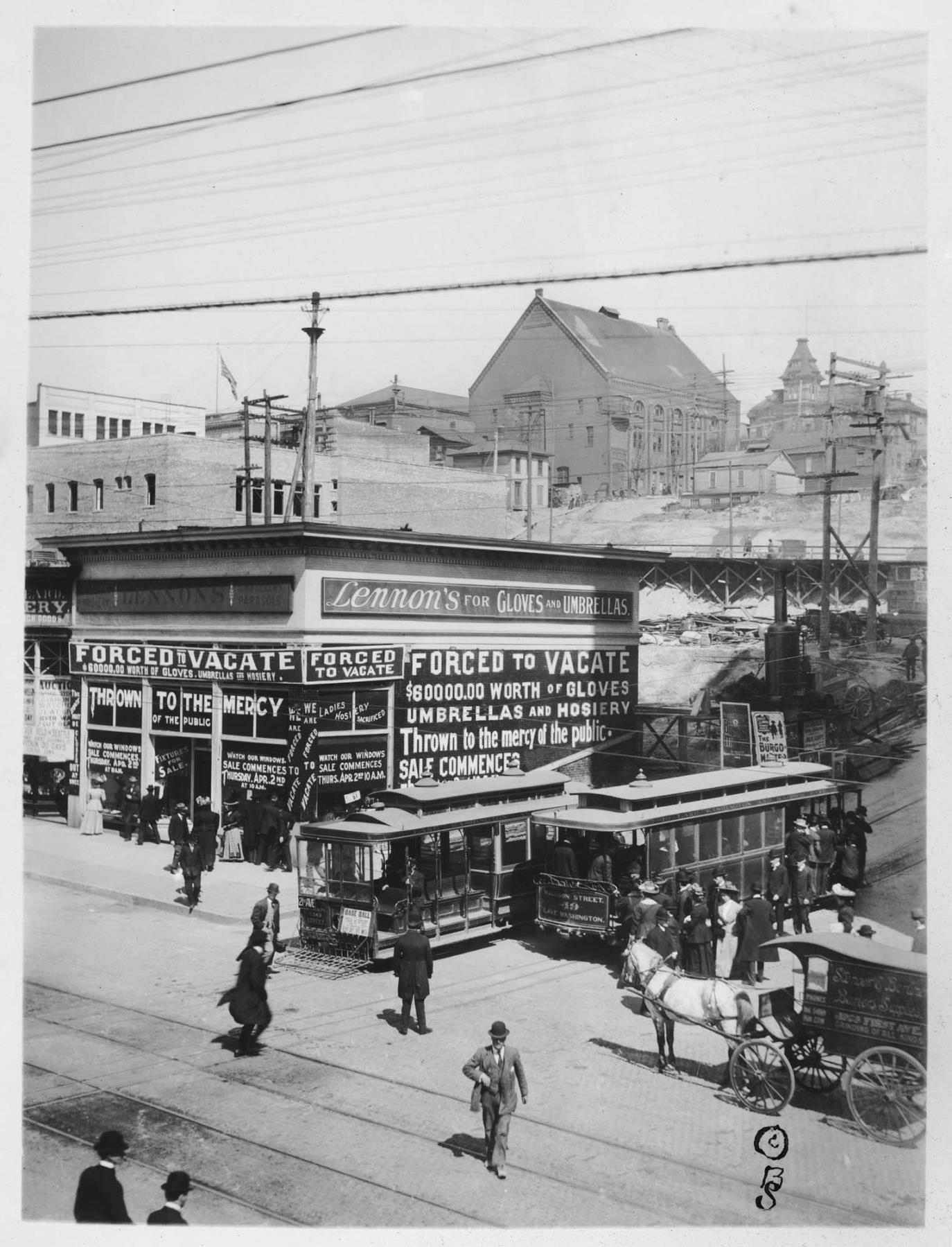 Image of Madison Street cable cars next to Lennon's store on Second Avenue, Seattle, circa 1910