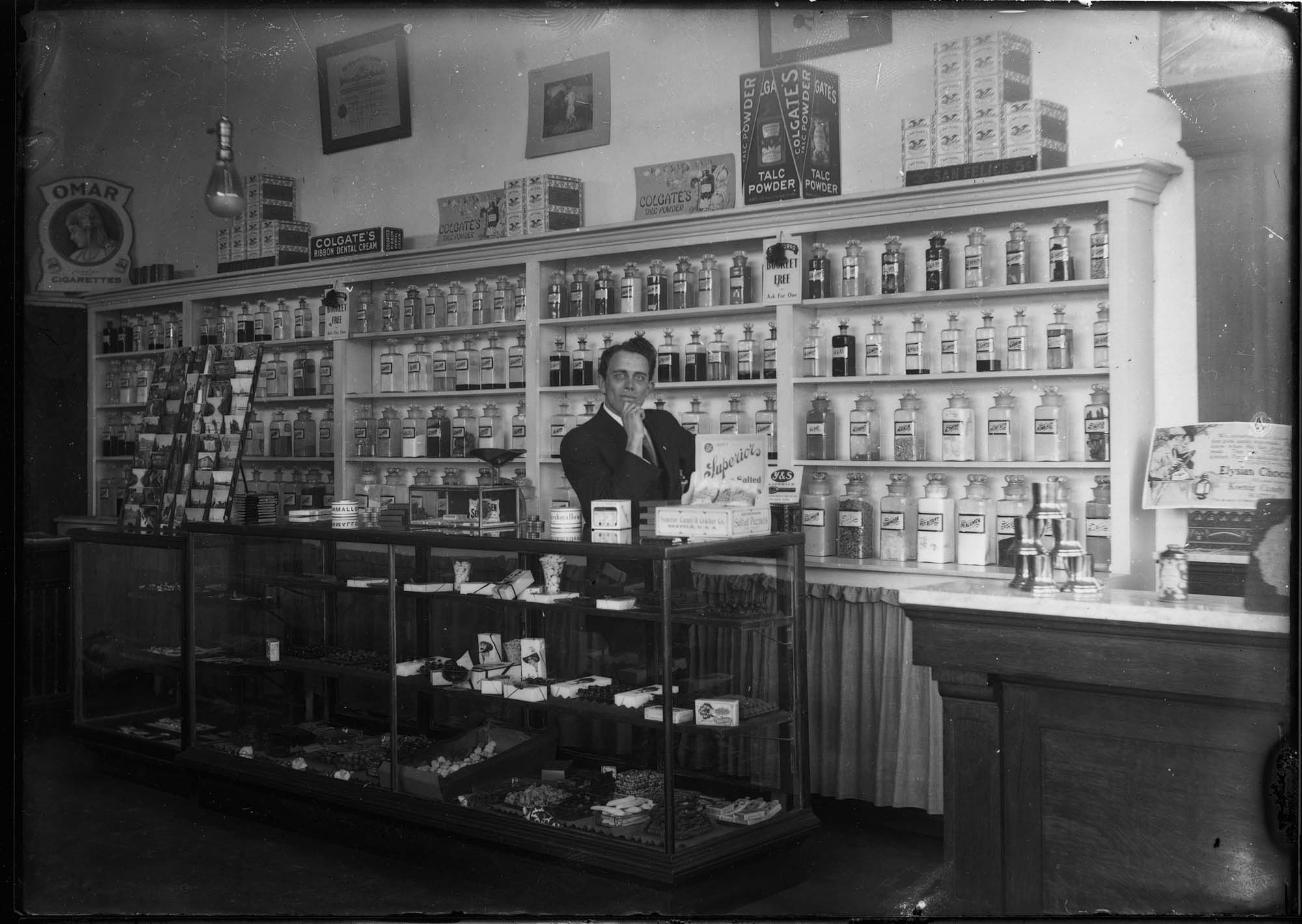 Image of Drugstore and barber shop, Seattle, circa 1910