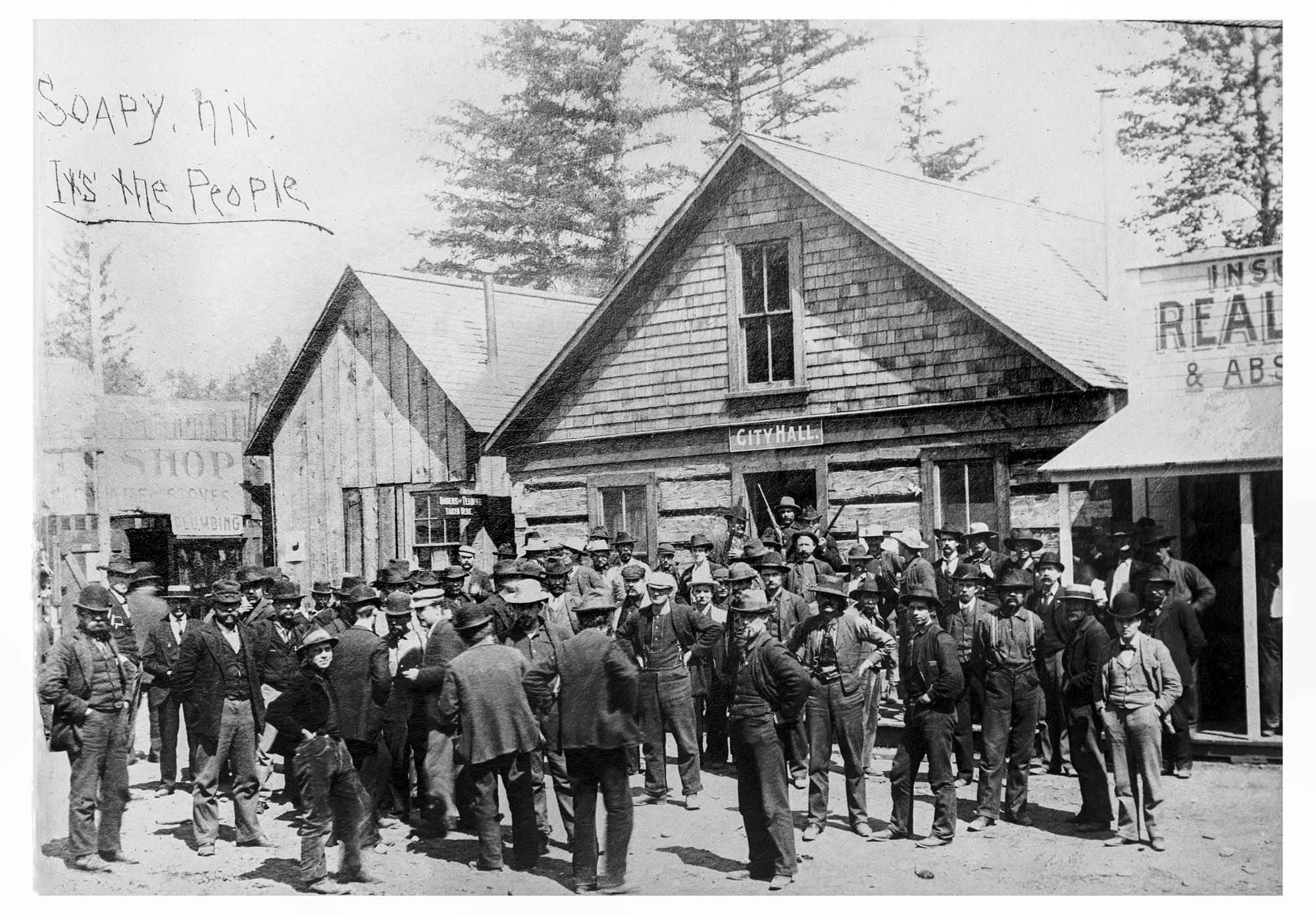 Image of Group outside Skagway City Hall, possibly a meeting about gangster Soapy Smith, circa 1898