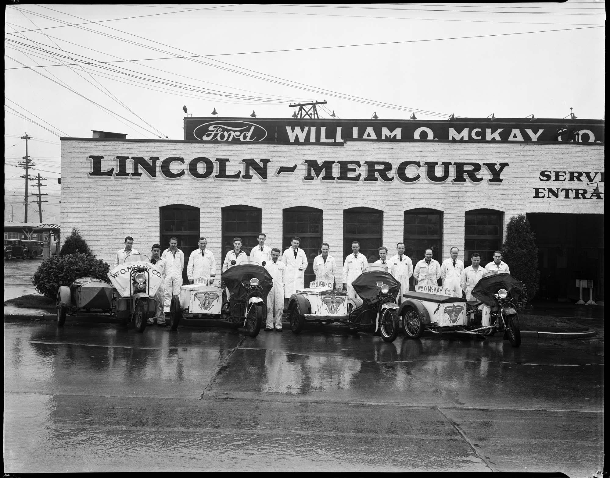 Image of Mechanics and motorcycles outside Wm. O. McKay Co. building, Seattle, November 13, 1939
