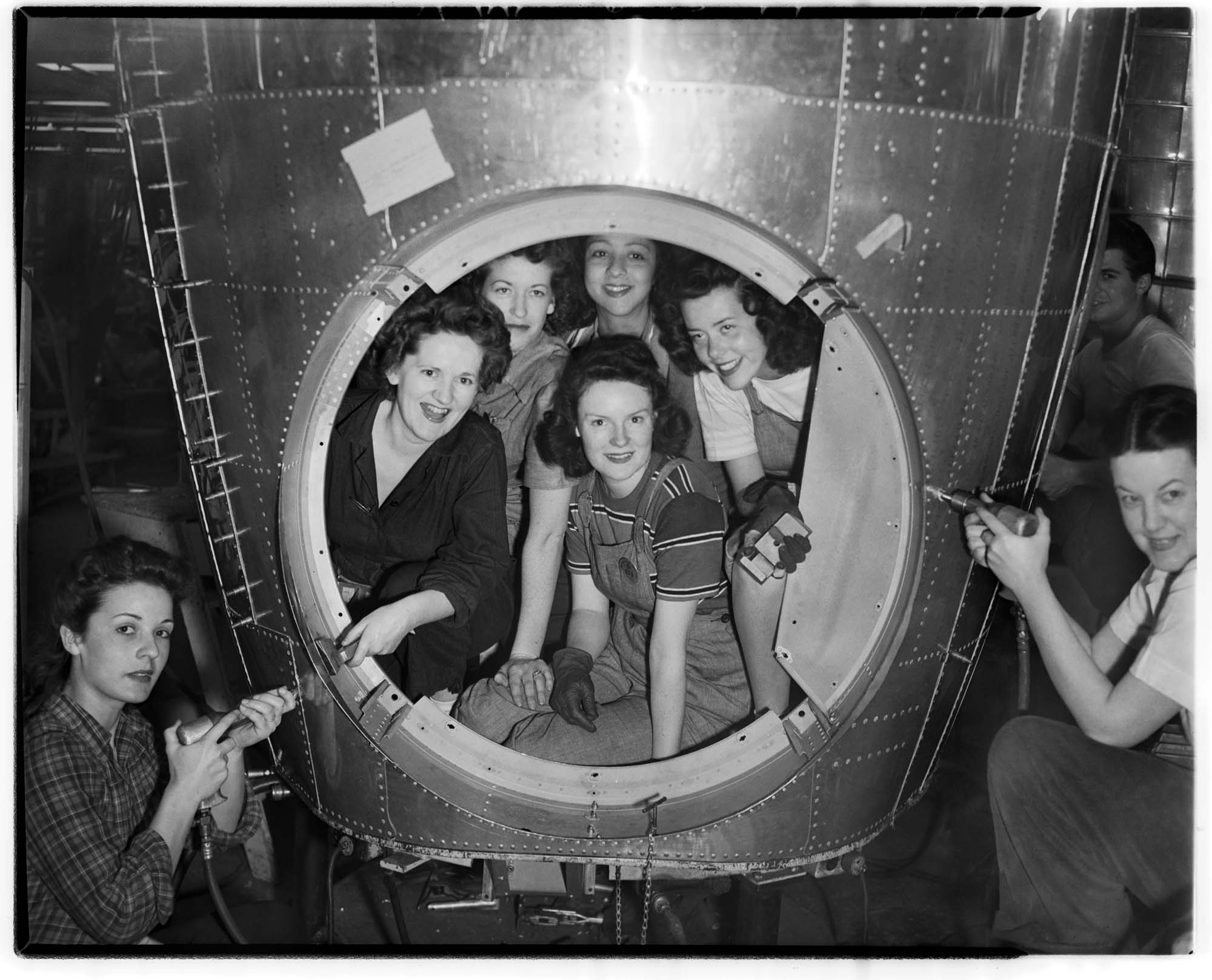Image of Kenworth workers posing with airplane part, Seattle, June 15, 1944
