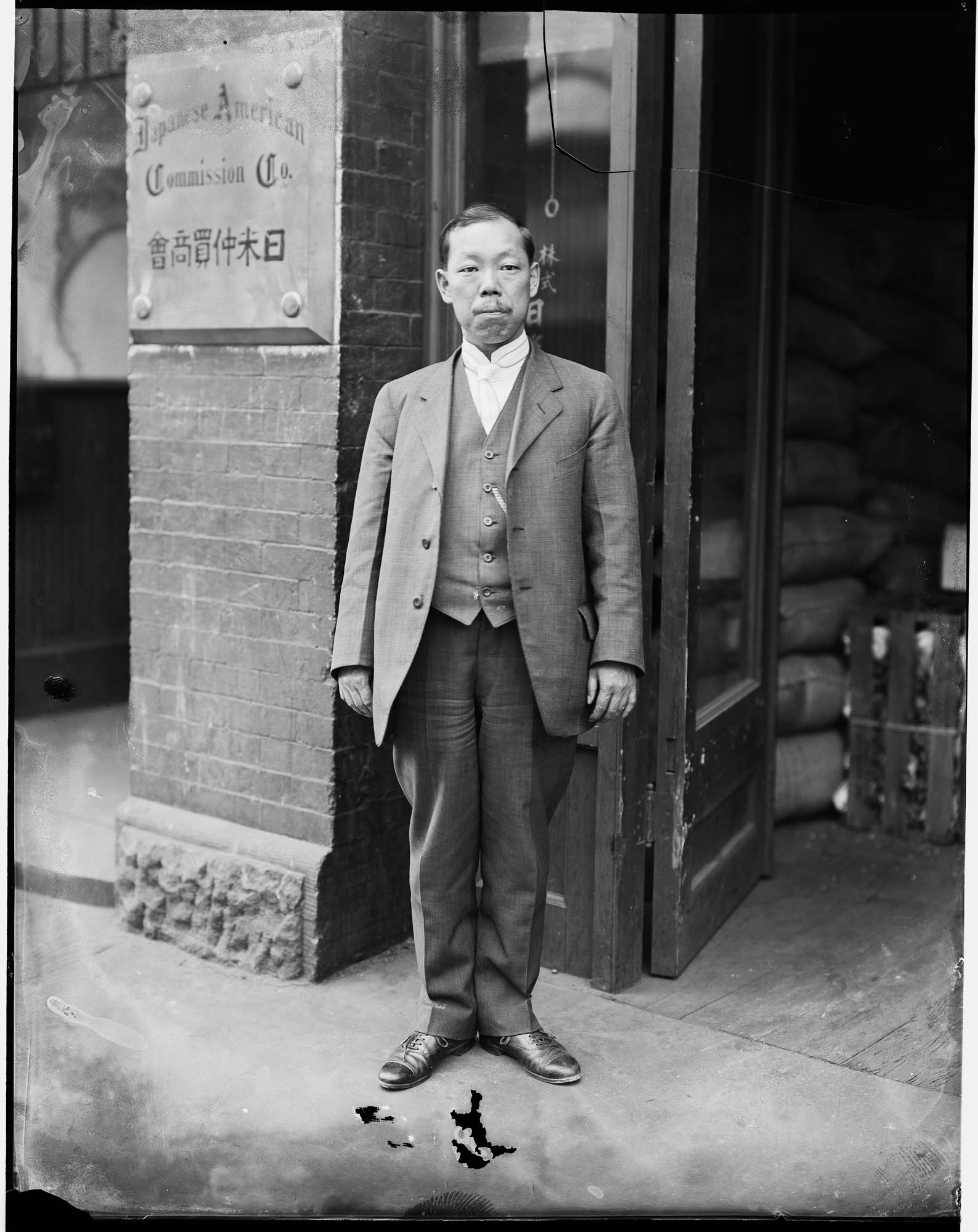 Image of Shozo Tsutakawa in front of the Japanese American Commission Company, Seattle, circa 1919