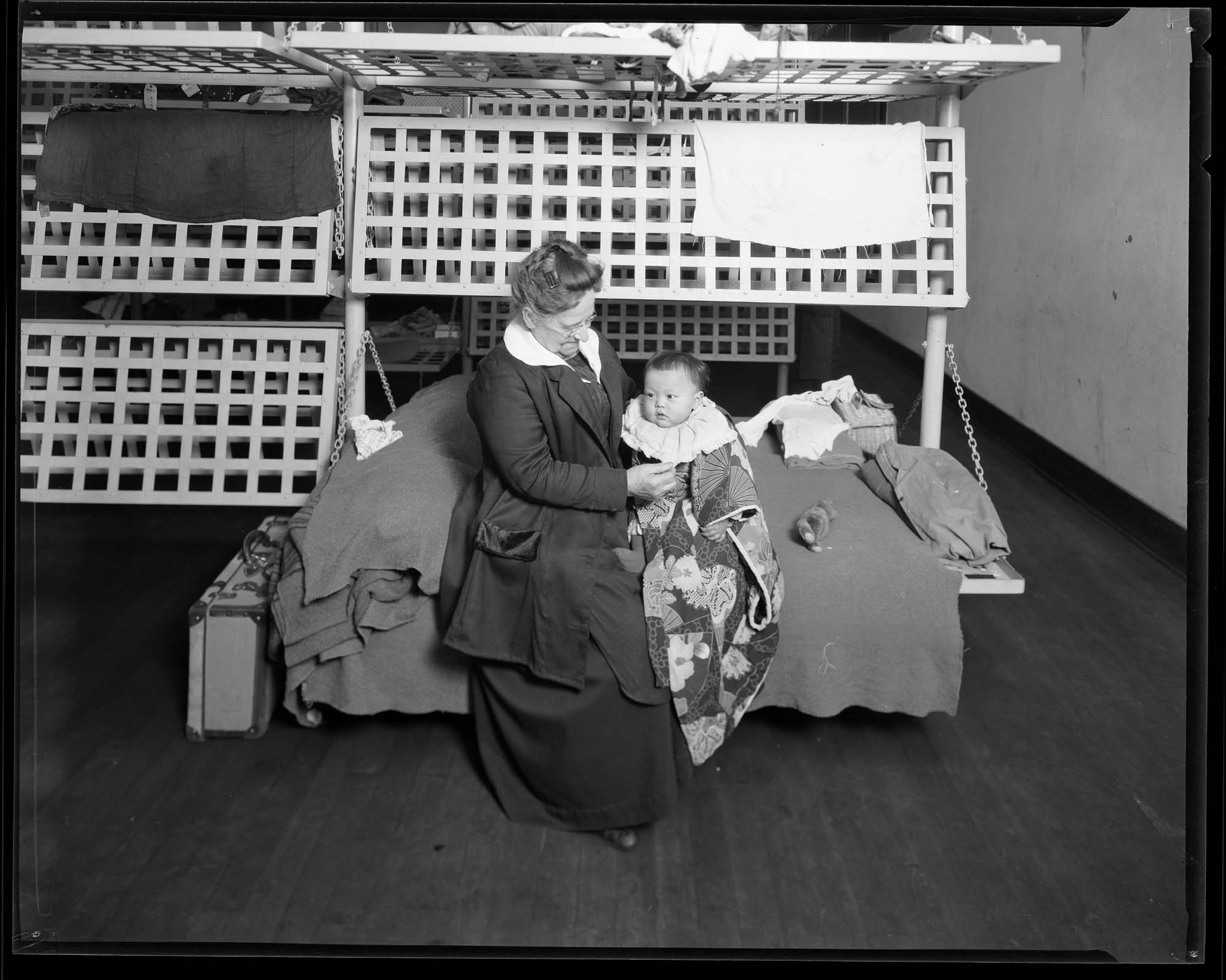 Image of Immigration staff member with Japanese baby, circa 1920