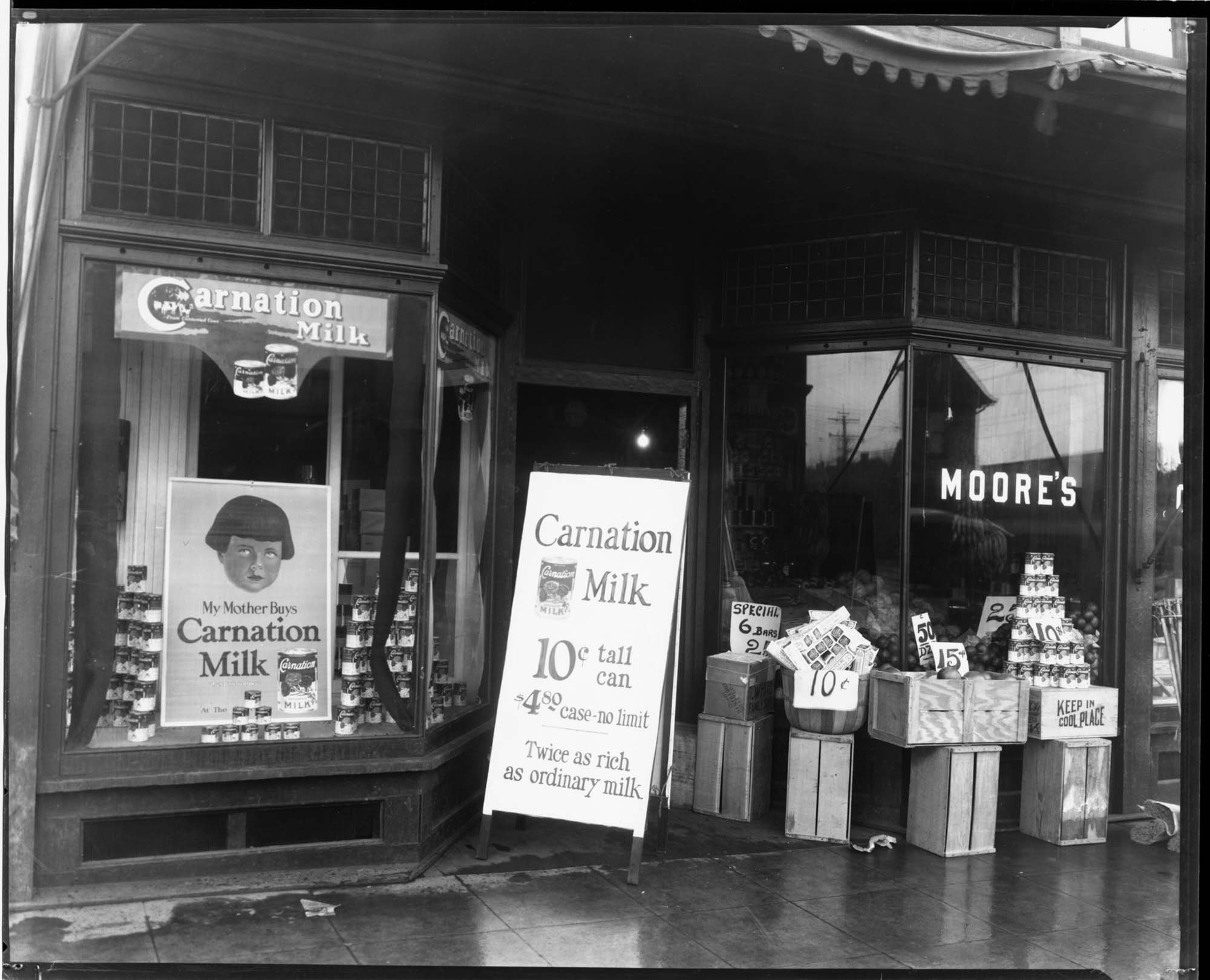 Image of Carnation Milk advertisements at Moore's, circa 1919