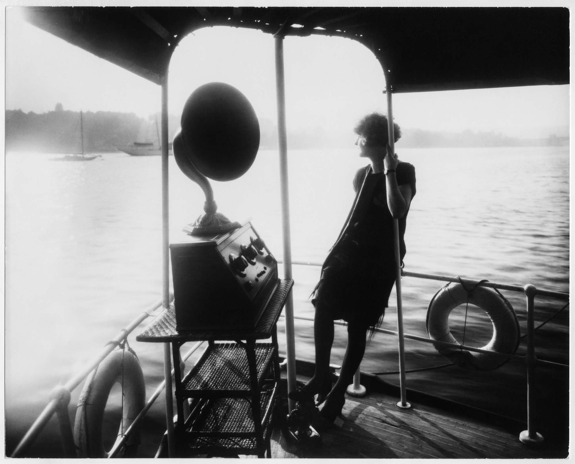 Image of Young woman listening to a radio on the yacht 