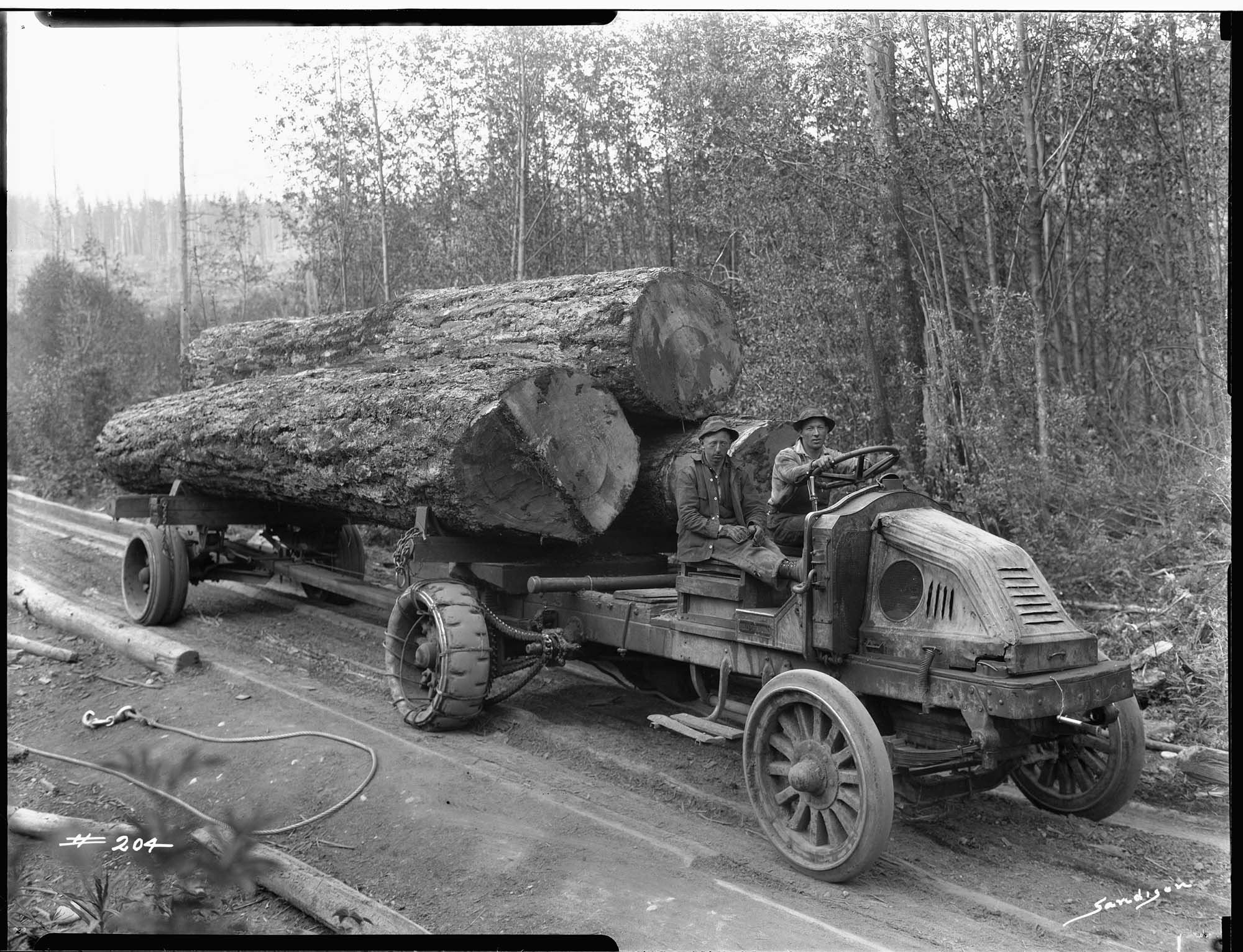 Image of Kelly-Springfield truck hauling logs, circa 1925