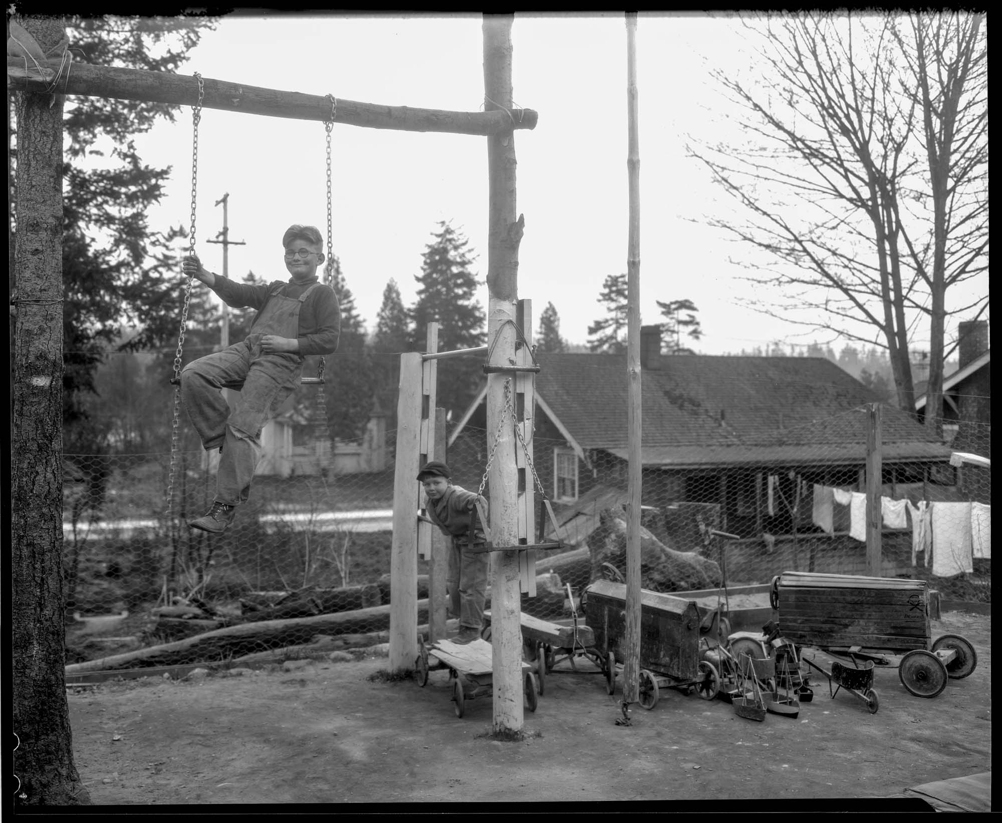Image of Two boys in their backyard playground, circa 1927